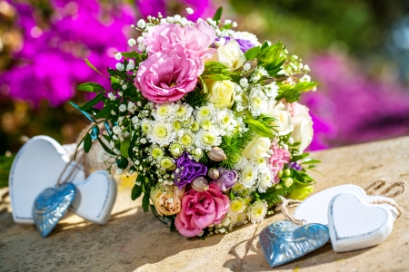 Bridal flower bouquet with decorative wooden hearts.の写真素材