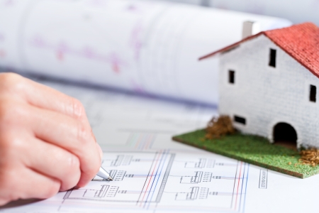 Close up of female hand doing housing layout.の写真素材