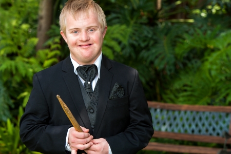Portrait of handicapped drummer boy in black suit outdoors.の写真素材