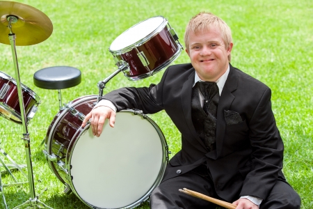 Portrait of young disabled musician next to drums outdoors.の写真素材