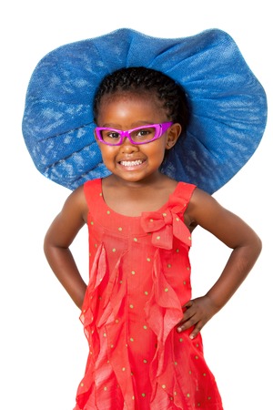 Comical portrait of small african girl wearing big blue hat.Isolated on white background.の写真素材