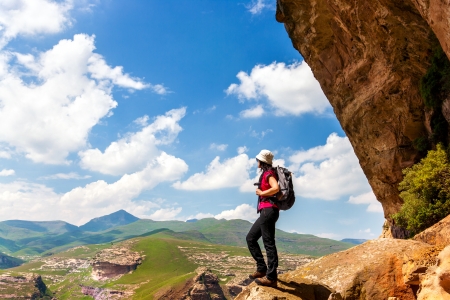 Female hiker standing on rock in mountains. の写真素材