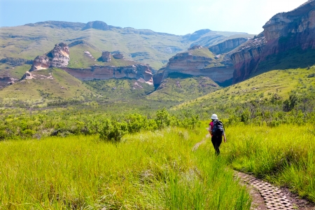 Young female tourist walking mountain trail in highlands.の写真素材