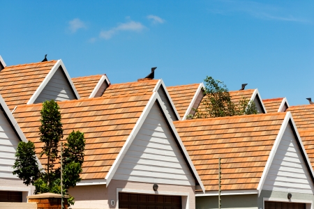 Close up detail of town house rooftops against blue sky.の写真素材