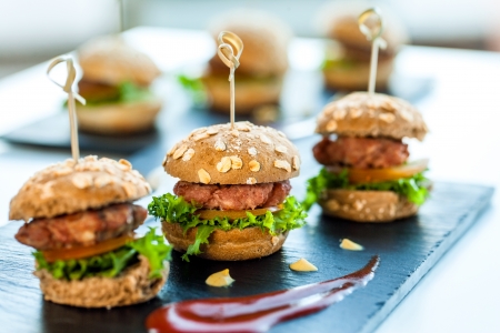 Close up of mini hamburgers at catering event.の写真素材