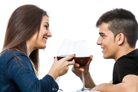 Close up portrait of cute couple drinking a glass of red wine together.Isolated on white background.の写真素材