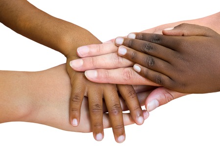 Macro close up of multiracial child hands joined together. Isolated on white background.