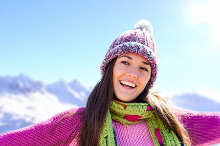 Young attractive snow girl wearing pink jersey and beanie outdoors の写真素材