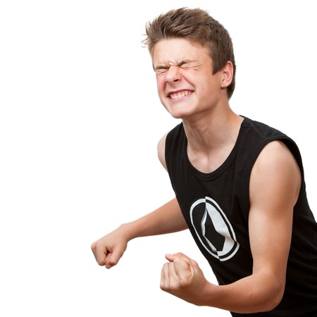Teen with winning attitude and eyes closed.Isolated on white background.の写真素材