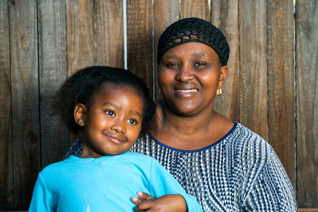 Portrait of young african mother with little daughter.の写真素材