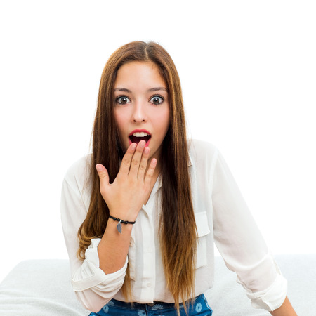 Close up portrait of teen girl with surprising face expression.Isolated on white background.の写真素材