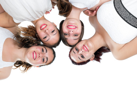 Beauty portrait of teen girlfriends joining heads.Isolated on white background.の写真素材