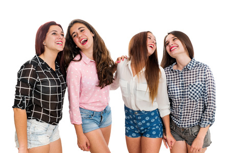 Portrait of teen girls having fun in studio.Isolated on white background.の写真素材