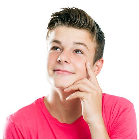 Close up portrait of Handsome teen boy looking at corner isolated.の写真素材