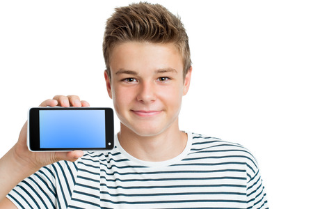 Close up portrait of Handsome teen showing smart phone with blank screen.Isolated on white background.の写真素材