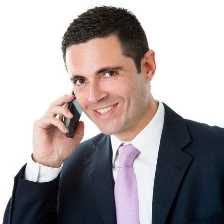 Close up studio Portrait of Attractive businessman in suit talking on smart phone.Isolated on white background.の写真素材