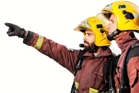 Two Firemen pointing with finger at fire isolated on white background.の写真素材