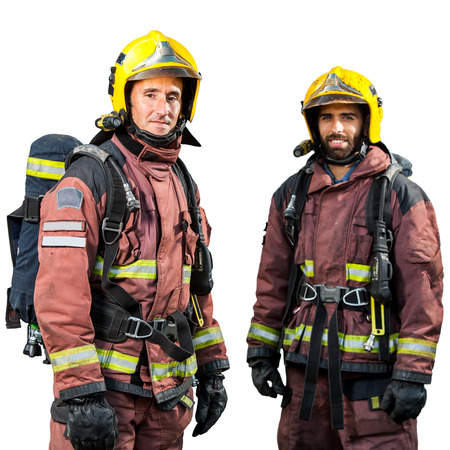 Two firemen wearing official fire fighting uniforms isolated on white background.の写真素材