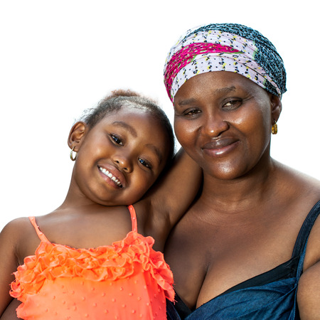 Close up portrait of little African girl sitting on mothers lap.Isolated on white background.の写真素材
