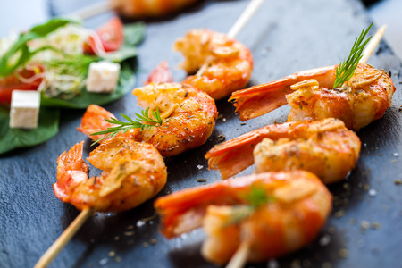 Macro close up of hot spicy char grilled queen prawn brochettes.の写真素材