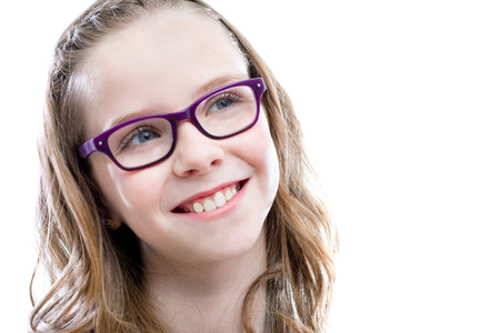 Close up portrait of Cute girl with glasses looking at upper corner.Isolated on white background.の写真素材