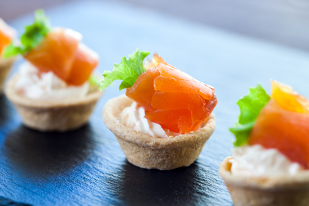 Macro close up of Appetizing Mini puff smoked salmon pastry tartlets for catering.の写真素材