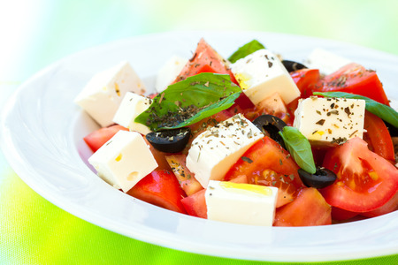 Macro close up of healthy mediterranean tomato mozzarella and fresh basil salad.の写真素材