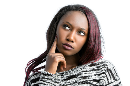 Close up portrait of attractive african teen girl looking at upper corner with wondering face expression.Isolated on white background.の写真素材