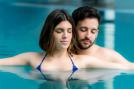 Close up portrait of Relaxed Couple with eyes closed in spa swimming pool.の写真素材