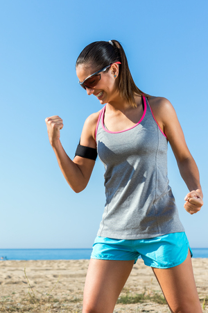 Close up portrait of exited athlete pulling a fist showing victory.の写真素材