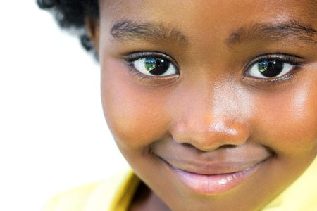 Extreme close up face shot of beautiful little african girl isolated on white background.