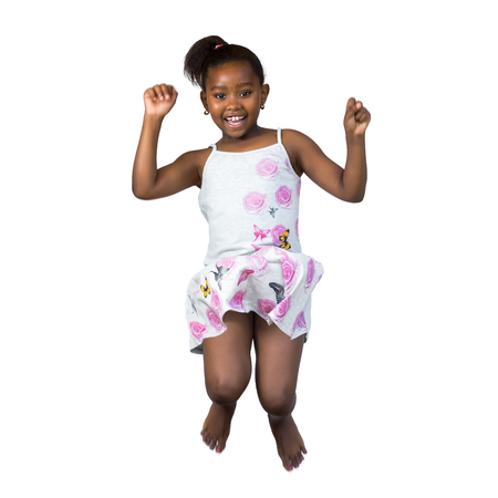 Close up portrait of happy little african girl jumping high wtih arms raised.Isolated on white background.の写真素材