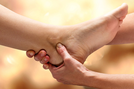 Close up of Kinesiologist doing therapy on female ankle.の写真素材