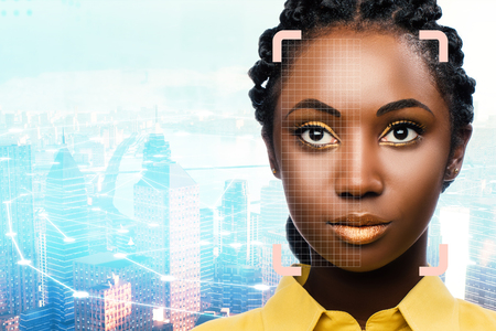 Close up portrait of facial recognition grid on african woman against city background.の写真素材