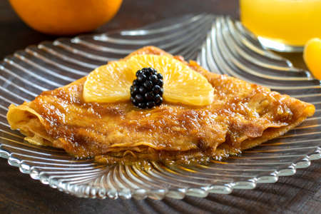 Macro close up of mouth watering thin pancake with caramelized orange sauce filling.の写真素材