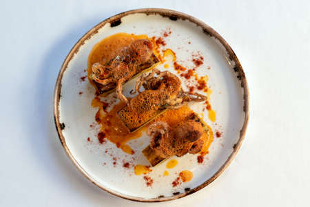 Top view of appetizing grilled octopus dish with potatoes and red paprika seasoning.の写真素材