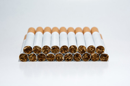 Nineteen cigarettes on a white backgroundの写真素材