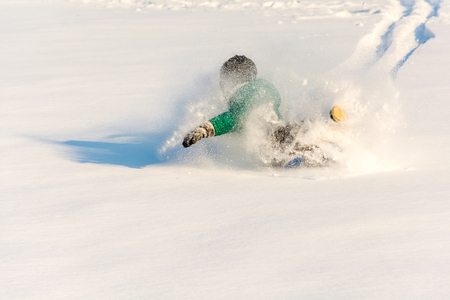 Boy playing in the snow. Sledding on a snowy hill. Winter games. Baby joy of snow. Throwing snowballs.の写真素材