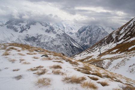 Mountain landscape with snow and cloudy sky. The Italian Alps, Ponte di Legno, Italy.の写真素材