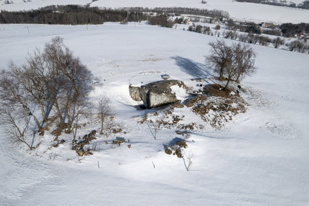 Abandoned concrete blockhouse on a hill covered with snow in winter. Kralicky Sneznik, Czechia.の写真素材