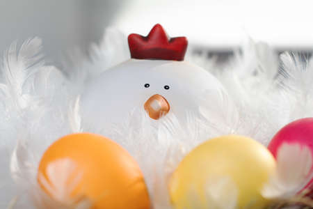 Close up of a nice easter decoration with a funny hen and colorful eggsの写真素材
