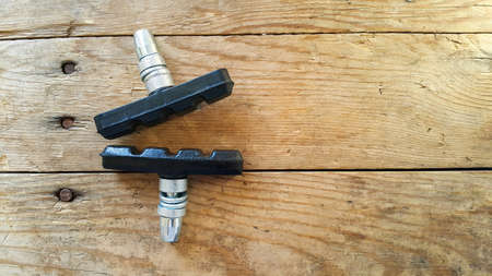Bicycle V-brake pads made of composite materials. Security concept. Space for text. The concept of the bike. The view from the top. Wooden background.の写真素材
