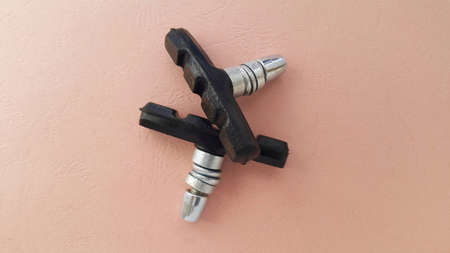 Bicycle V-shaped brake pads are made of composite materials. Security concept. Space for text. The concept of the bike. The view from the top. Coral background.の写真素材