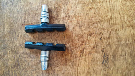 Bicycle V-brake pads made of composite materials. Security concept. Space for text. The concept of the bike. The view from the top. Wooden background.の写真素材