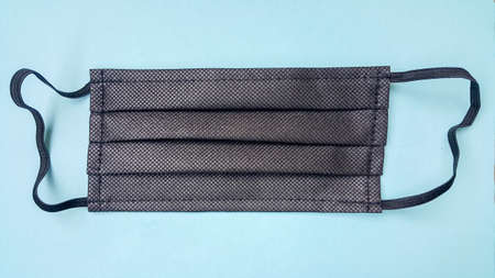 face mask on a blue background. Medical item for protection against coronavirus by airborne droplets.の写真素材