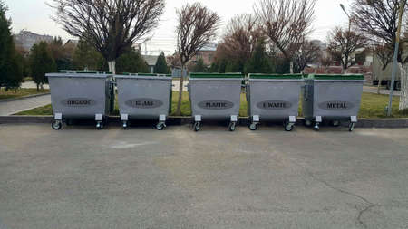 Five gray trash bins installed in the city for various types of materials. Zero waste. Containers for metal, glass, plastic, e waste and organic waste. Eco planet.の写真素材