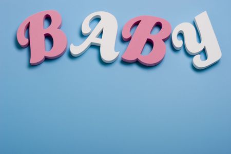 pink and white  letters on blue backgroundの写真素材