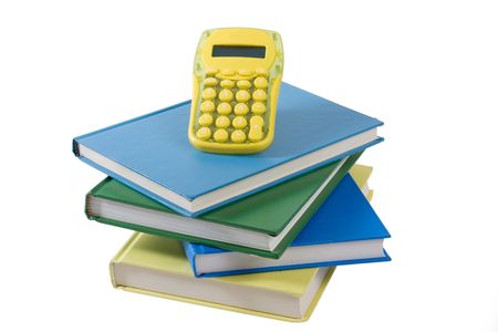 Stack of colorful books with bright yellow calculator isolated on white backgroundの写真素材