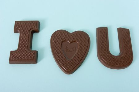 Chocolates in the shape of I love you with a blue backgroundの写真素材