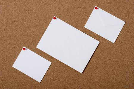 A cork bulletin board with three blank cards for your message